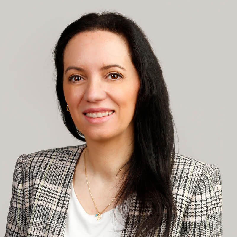 A portrait of Patty Zakaria smiling