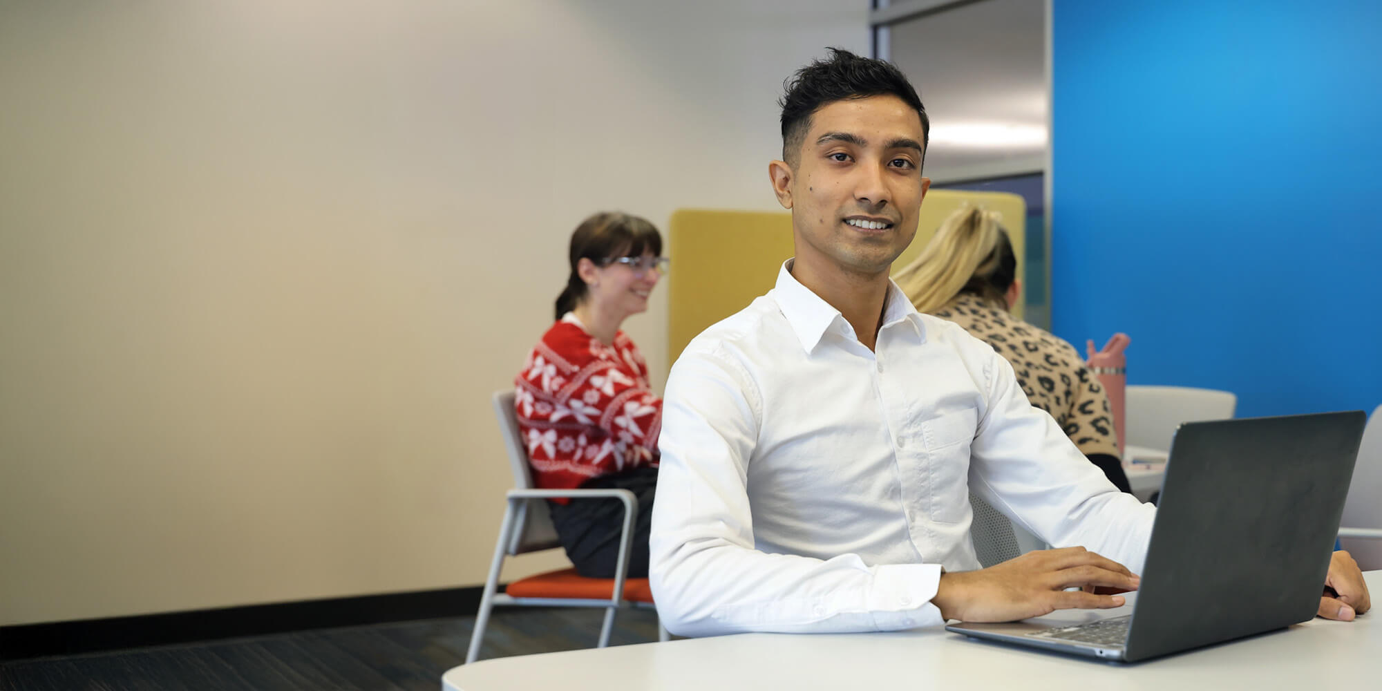 A student looking at camera while sitting in classroom