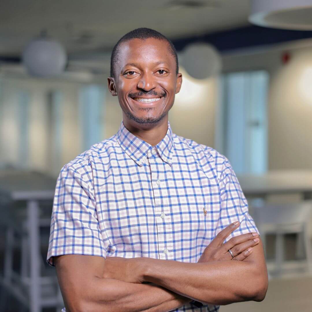 A portrait Moses Oto-Obong Eshiet smiling for the camera