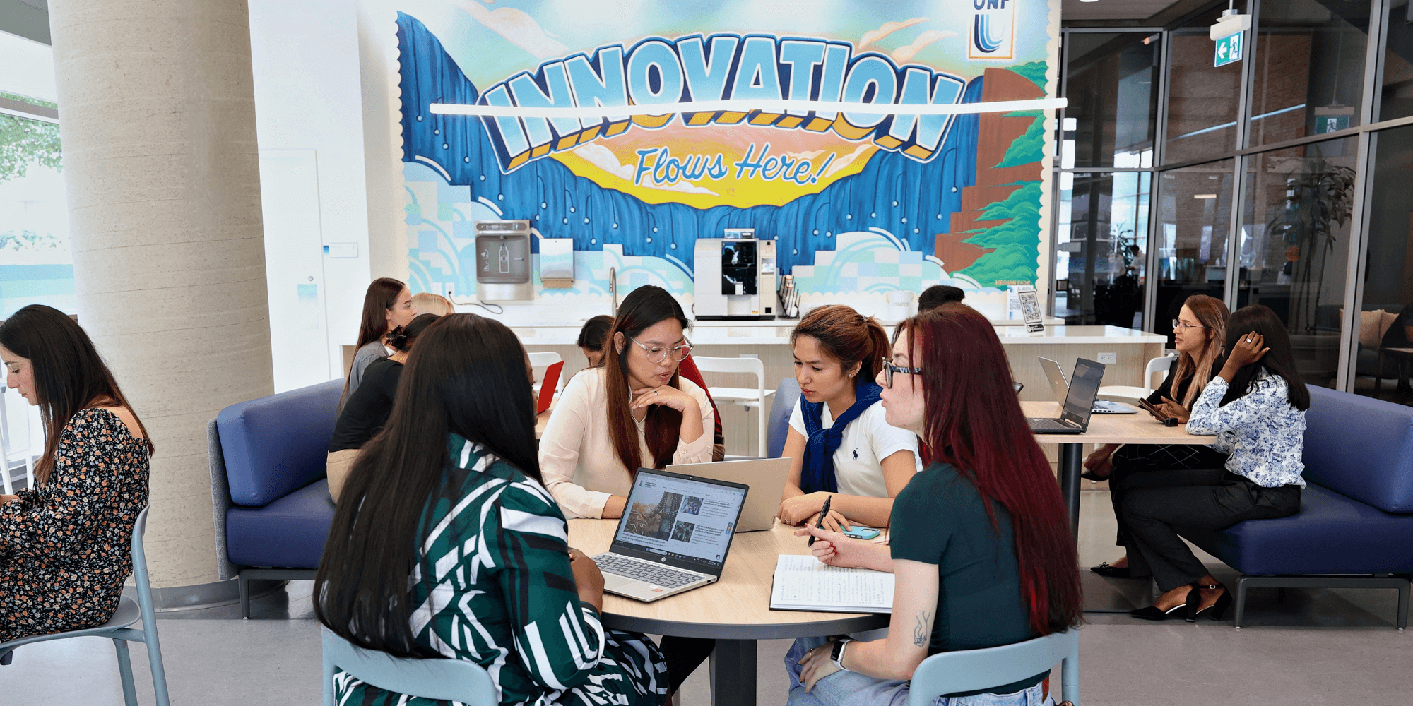 Groups of Students studying in a common area inside UNF campus