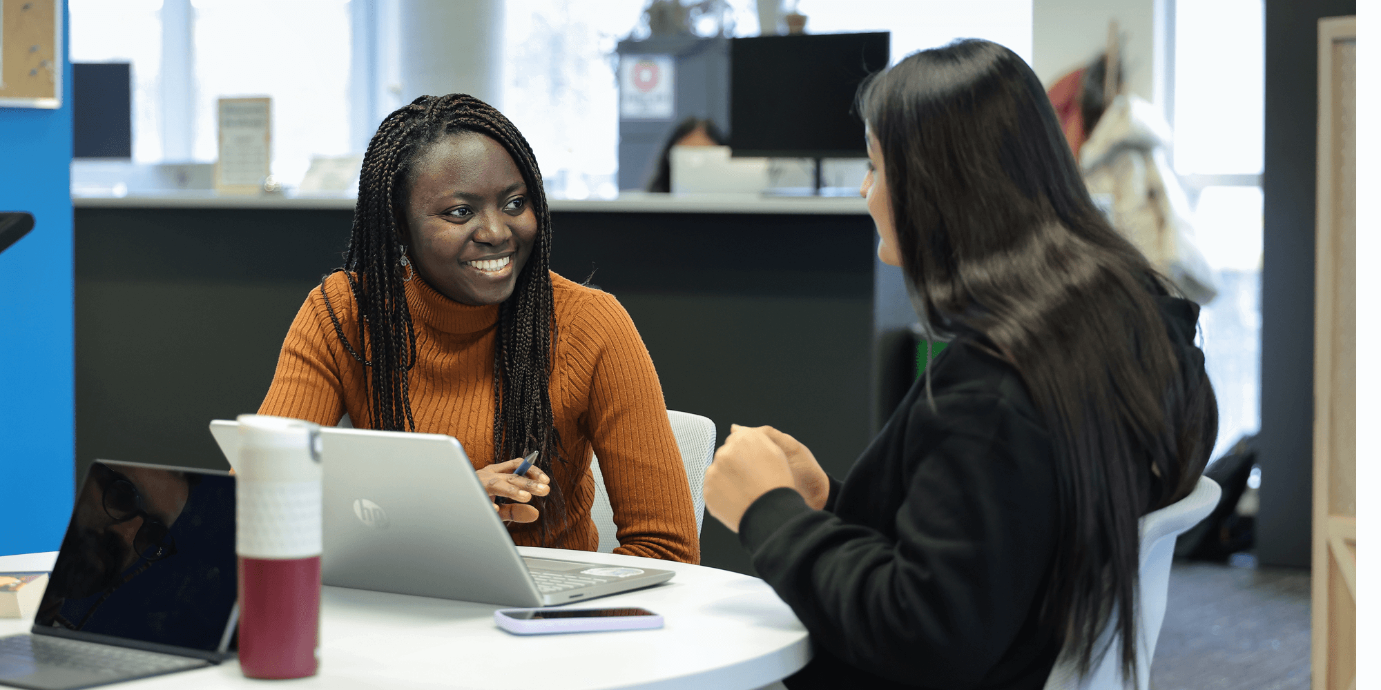 two female students talking inside UNF campus