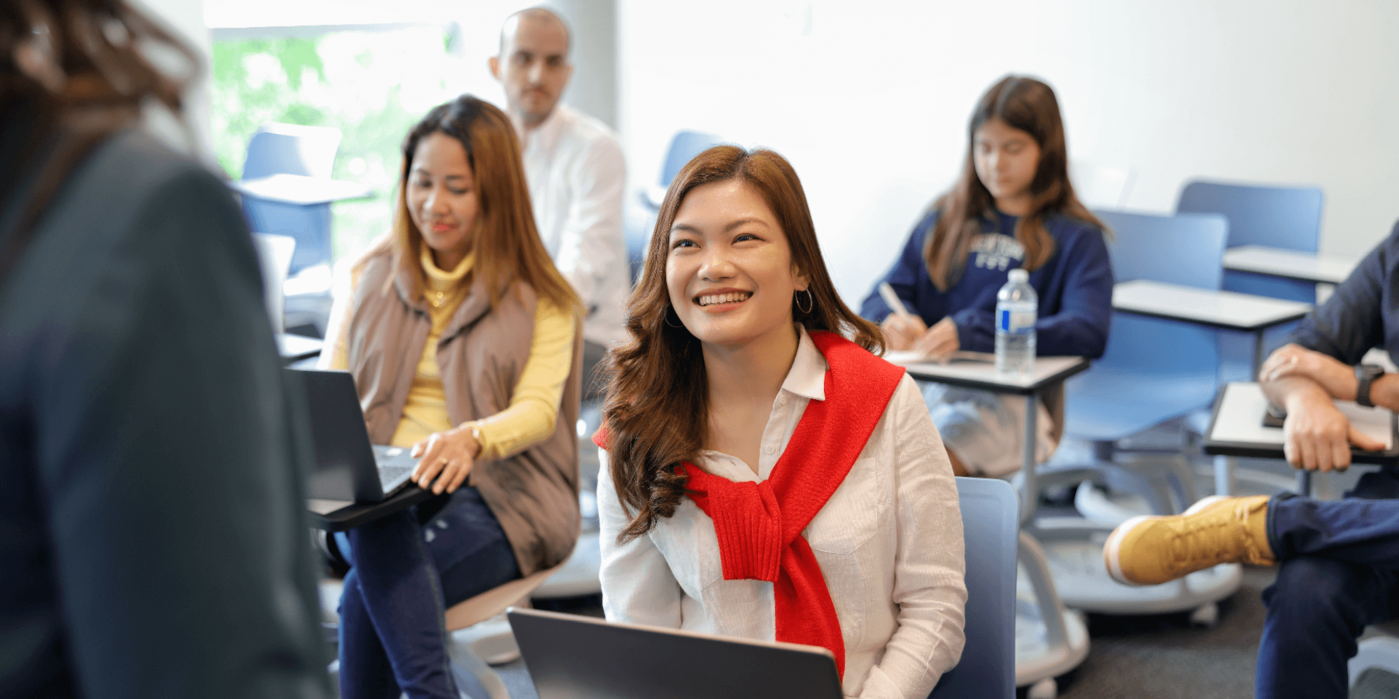 Several students in a classroom setting, engaged in a learning activity together