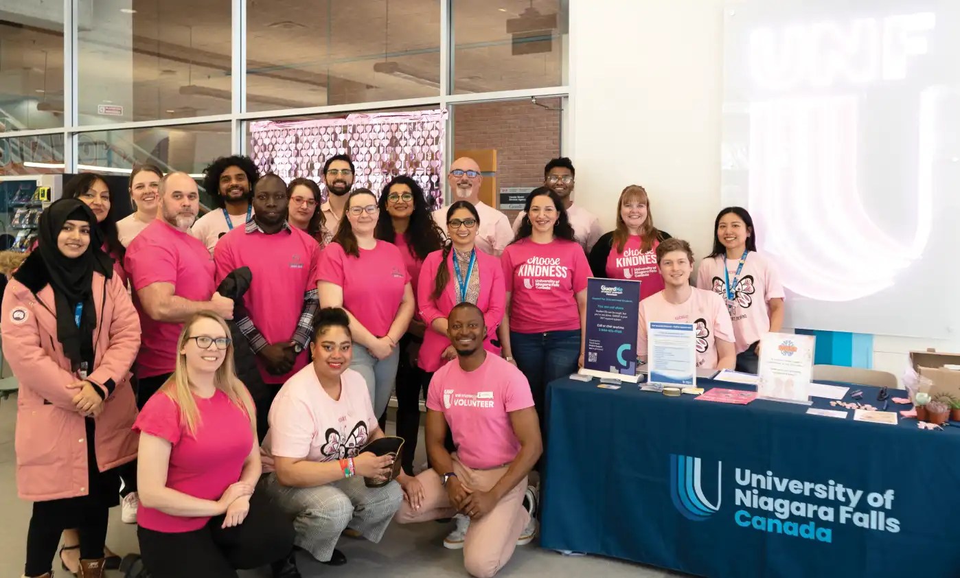 Group of UNF staffs and students posing for a picture during the Pink Day event